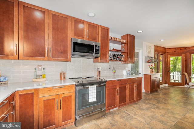 kitchen with stainless steel appliances, tasteful backsplash, open shelves, recessed lighting, and light countertops