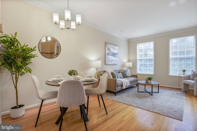 dining area featuring baseboards, wood finished floors, a chandelier, and ornamental molding