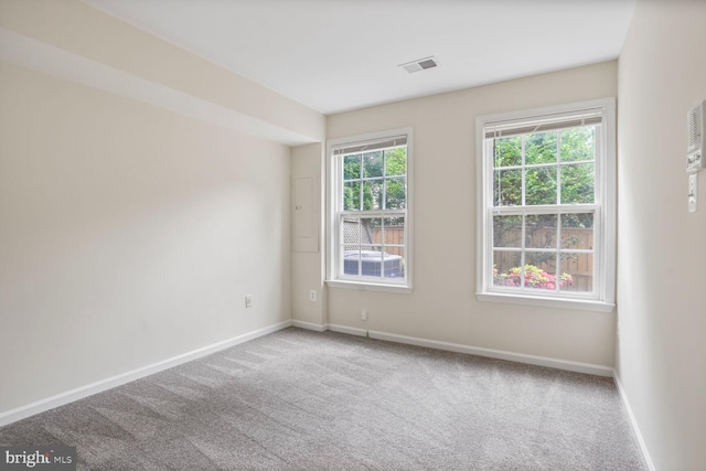 empty room with baseboards and carpet flooring