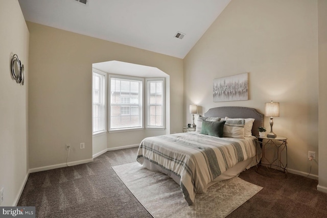 carpeted bedroom featuring lofted ceiling and baseboards