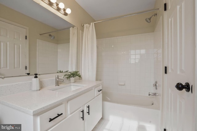 bathroom with shower / bath combo with shower curtain, vanity, and tile patterned flooring