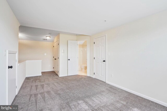 unfurnished room featuring carpet flooring and baseboards