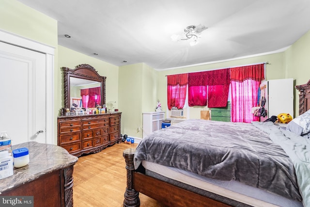 bedroom with wood finished floors and cooling unit