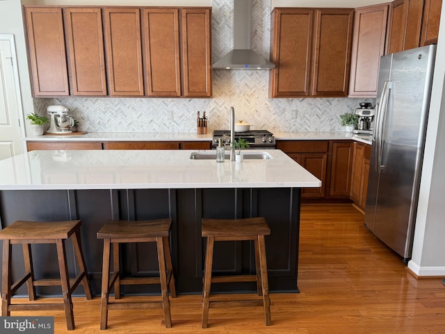 11897 Benton Lake Rd, Bristow, VA 20136 - kitchen featuring wall chimney range hood, stainless steel refrigerator with ice dispenser, wood finished floors, and brown cabinets