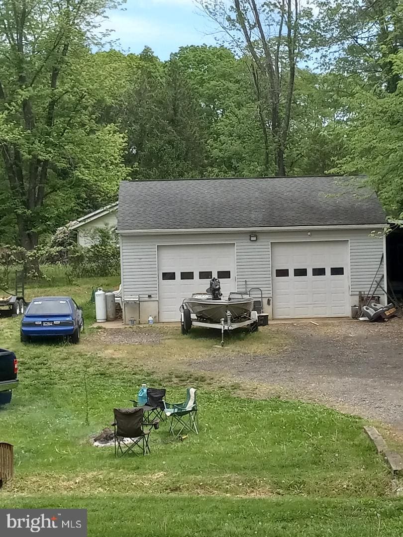 garage with dirt driveway