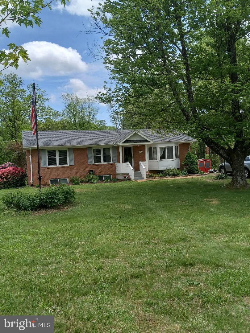 single story home featuring a front lawn and brick siding