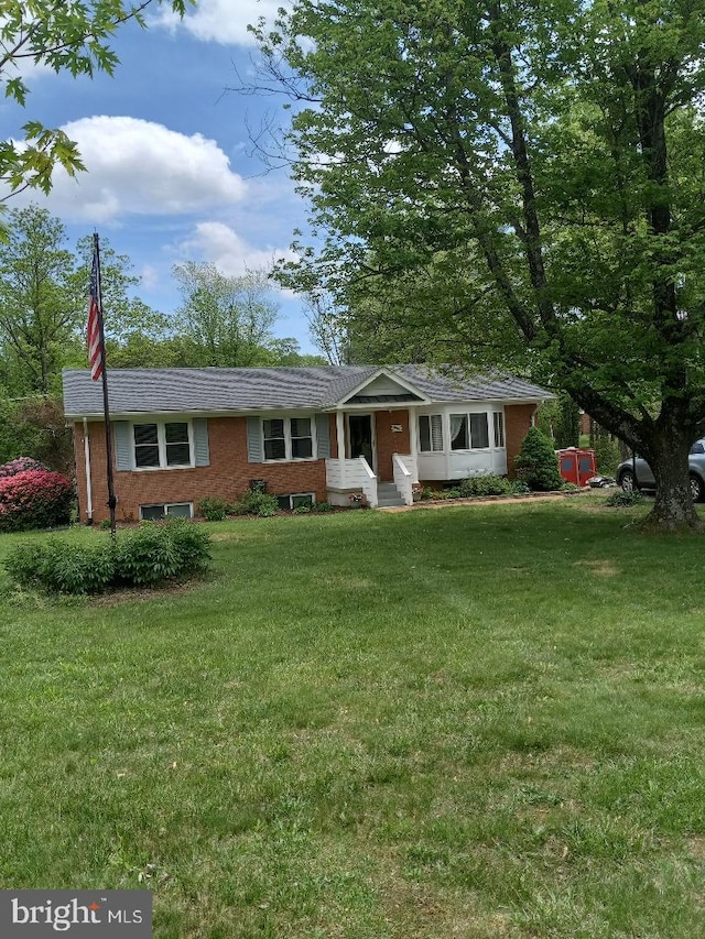 single story home featuring a front lawn and brick siding
