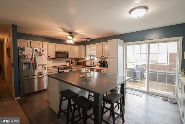 230 Jewel Dr, York, PA 17404 - kitchen featuring appliances with stainless steel finishes, dark wood finished floors, backsplash, a ceiling fan, and a sink
