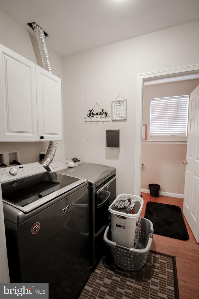 230 Jewel Dr, York, PA 17404 - washroom with cabinet space, washing machine and clothes dryer, dark wood-type flooring, and baseboards