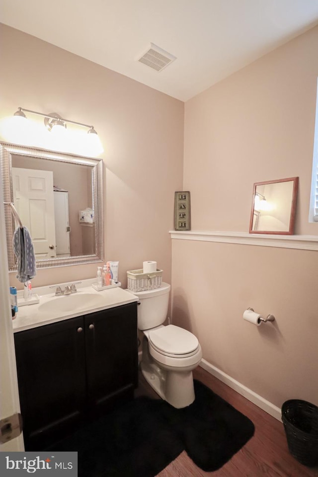 230 Jewel Dr, York, PA 17404 - half bath with wood finished floors, toilet, vanity, and baseboards