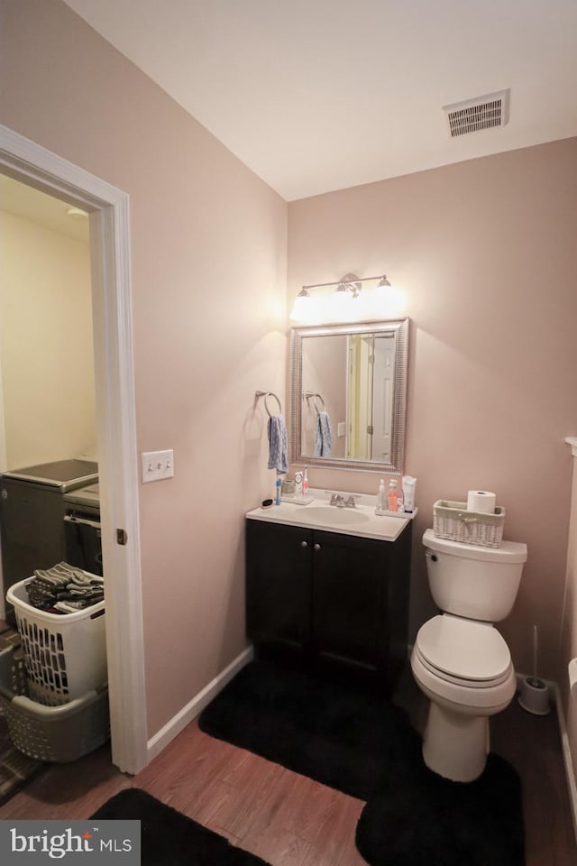 230 Jewel Dr, York, PA 17404 - half bath with wood finished floors, vanity, baseboards, and toilet
