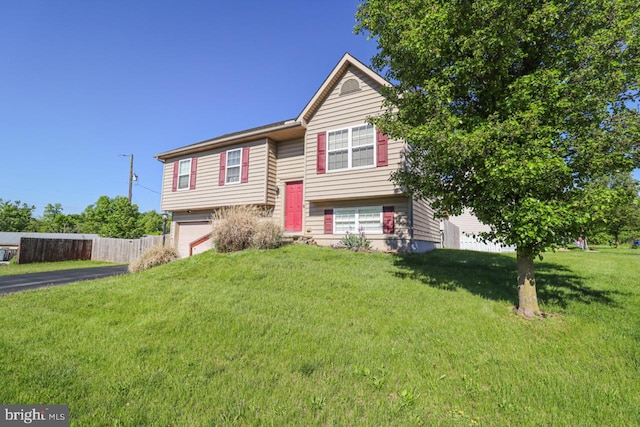 230 Jewel Dr, York, PA 17404 - raised ranch featuring a garage, a front lawn, and asphalt driveway