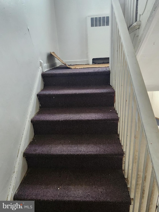 staircase featuring radiator