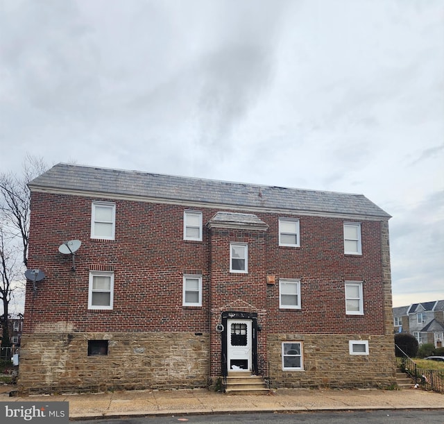 view of front of house featuring brick siding and entry steps