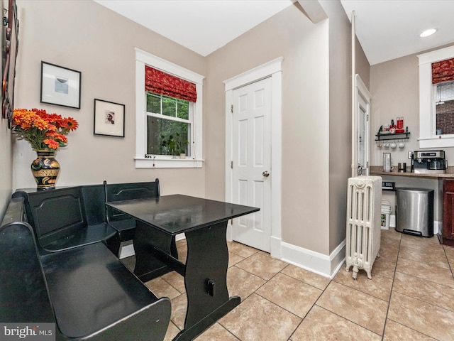 dining room with light tile patterned floors, baseboards, radiator heating unit, and recessed lighting