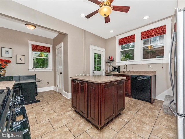 kitchen with freestanding refrigerator, dishwasher, a wealth of natural light, and light countertops