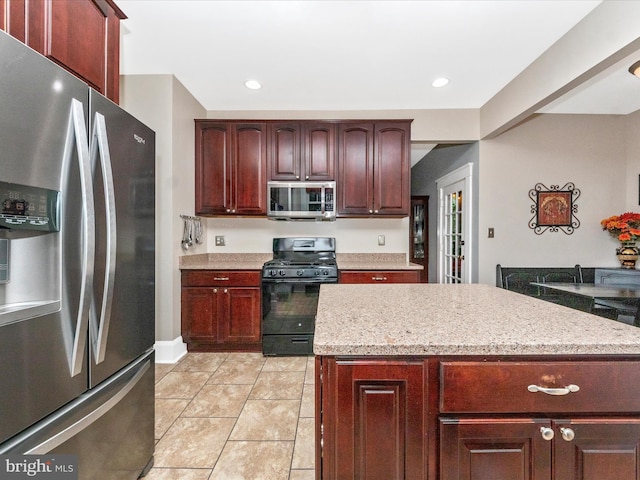 kitchen featuring a center island, light tile patterned floors, stainless steel appliances, and recessed lighting