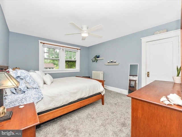 bedroom featuring baseboards, radiator heating unit, ceiling fan, and carpet floors