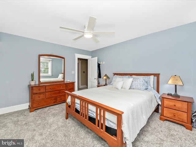 carpeted bedroom with baseboards and a ceiling fan