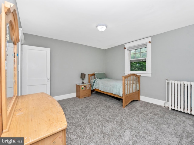 carpeted bedroom with baseboards and radiator