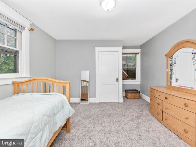 carpeted bedroom featuring baseboards
