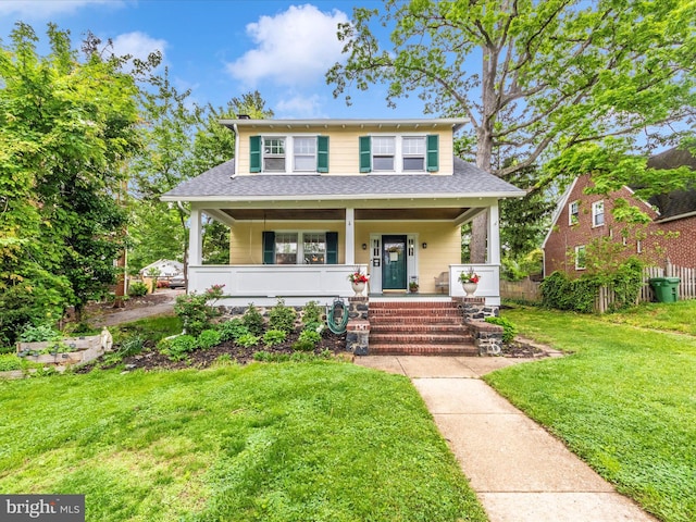bungalow-style home featuring a porch, roof with shingles, and a front lawn