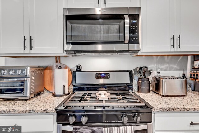 305 Maple Run Dr, York, PA 17404 - kitchen featuring stainless steel appliances, white cabinetry, and light stone counters