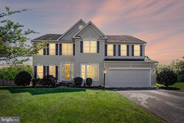 view of front of property with driveway, a garage, and a front lawn