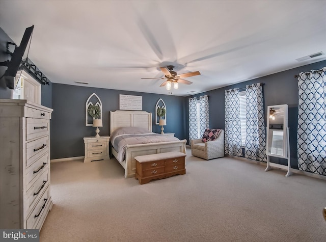 bedroom featuring light carpet, ceiling fan, and baseboards