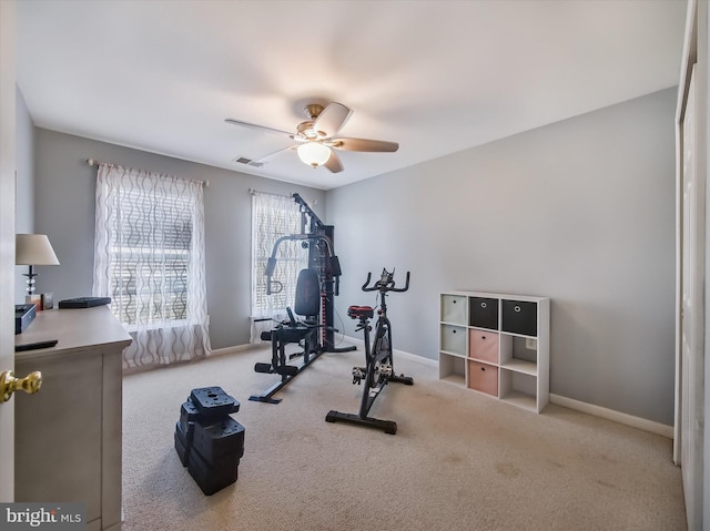 exercise room featuring ceiling fan, carpet flooring, and baseboards