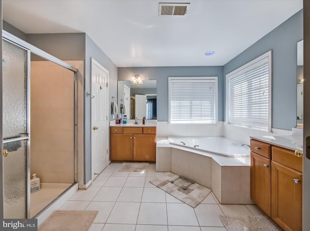 bathroom with a shower stall, a bath, vanity, and tile patterned floors