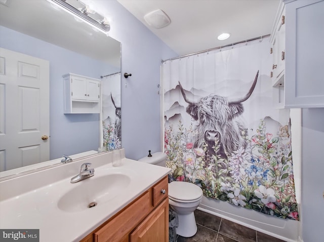 bathroom featuring tile patterned flooring, toilet, and vanity