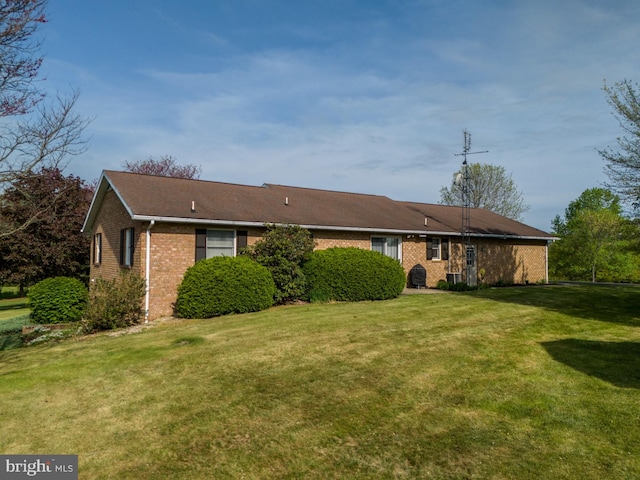 view of front of property with brick siding and a front lawn