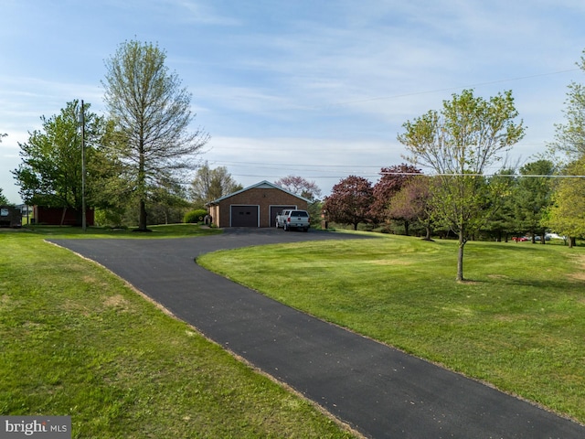 view of front of home featuring a garage and a front lawn