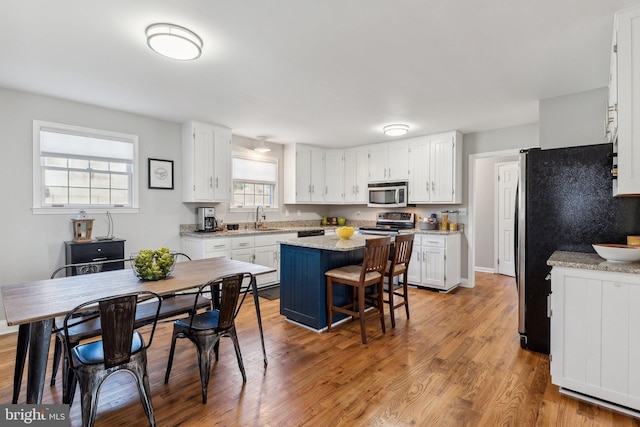 2994 Hope Mill Ln, Adamstown, MD 21710 - kitchen featuring white cabinetry, appliances with stainless steel finishes, a sink, and a center island