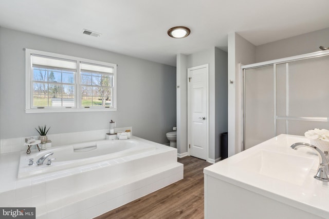 2994 Hope Mill Ln, Adamstown, MD 21710 - bathroom featuring a garden tub, visible vents, a stall shower, wood finished floors, and toilet