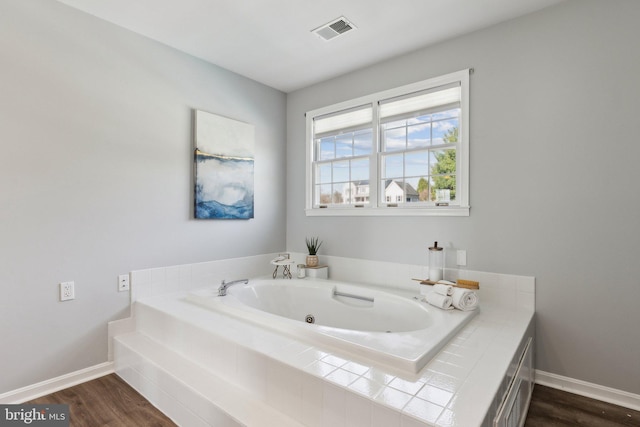 2994 Hope Mill Ln, Adamstown, MD 21710 - bathroom with baseboards, a tub with jets, wood finished floors, and visible vents