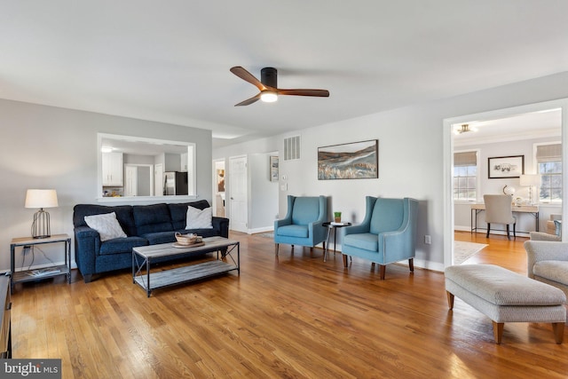 2994 Hope Mill Ln, Adamstown, MD 21710 - living room with visible vents, a ceiling fan, baseboards, and wood finished floors