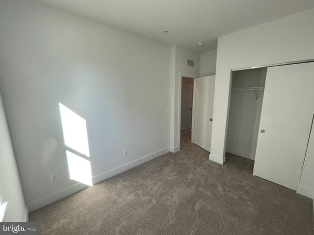 12 Mural Walk NE, Washington, DC 20011 - unfurnished bedroom featuring a closet, baseboards, carpet flooring, and visible vents