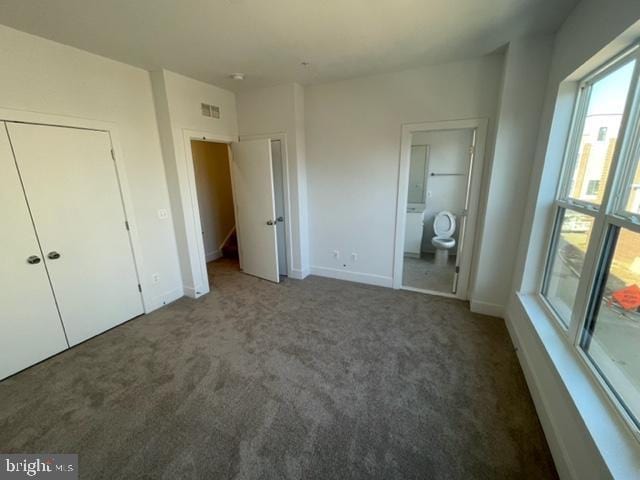 12 Mural Walk NE, Washington, DC 20011 - unfurnished bedroom featuring baseboards, carpet, connected bathroom, and visible vents