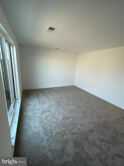12 Mural Walk NE, Washington, DC 20011 - unfurnished room featuring baseboards, dark carpet, and visible vents