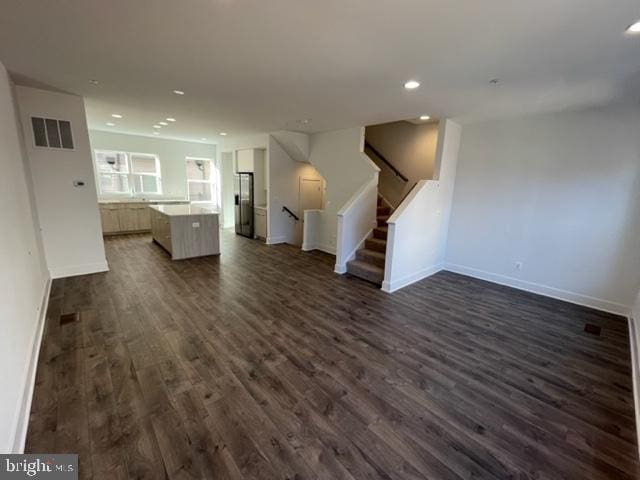 12 Mural Walk NE, Washington, DC 20011 - unfurnished living room with recessed lighting, baseboards, dark wood-type flooring, visible vents, and stairway
