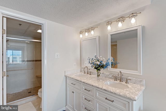 11 142nd St Unit 31003, Ocean City, MD 21842 - bathroom with a stall shower, toilet, double vanity, and a textured ceiling