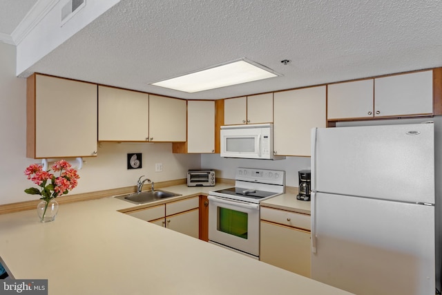 11 142nd St Unit 31003, Ocean City, MD 21842 - kitchen featuring white appliances, a sink, a textured ceiling, light countertops, and cream cabinetry