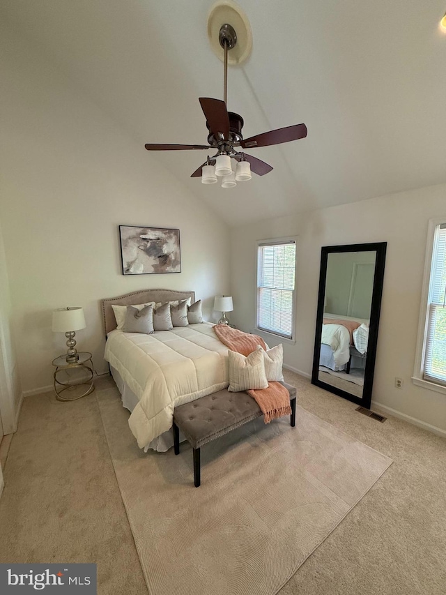 bedroom with light colored carpet, visible vents, vaulted ceiling, a ceiling fan, and baseboards