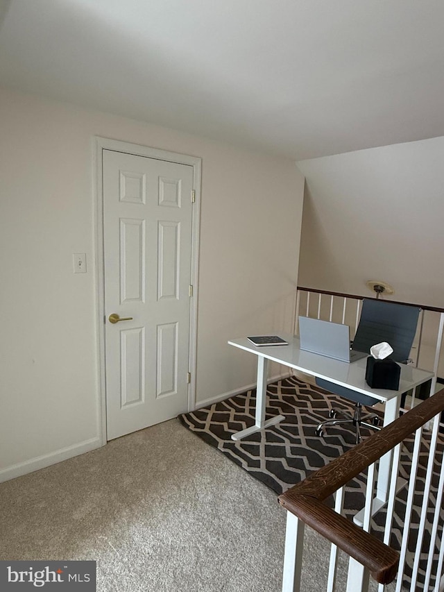interior space featuring baseboards and carpet flooring