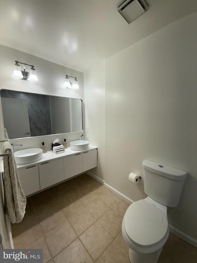 bathroom featuring toilet, visible vents, tile patterned flooring, and a sink