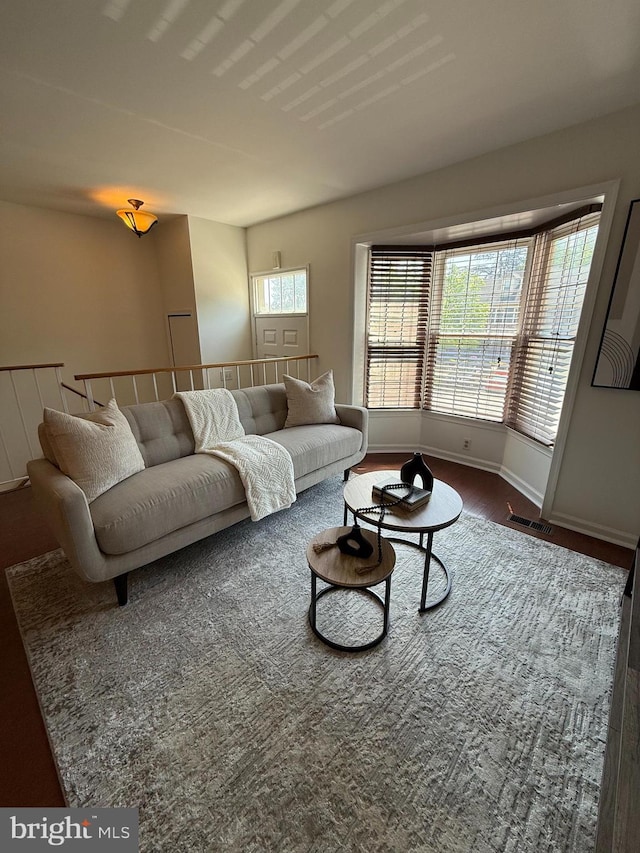 living room with baseboards and visible vents
