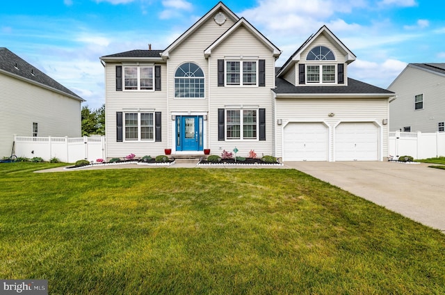 colonial-style house featuring fence, a garage, a front lawn, and concrete driveway
