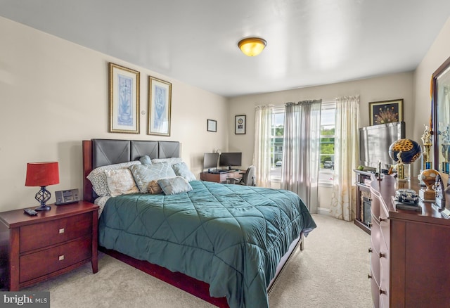 bedroom featuring light carpet